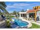 Serene backyard featuring a freeform pool, mature landscaping, and a covered patio for outdoor enjoyment at 10013 N 106Th Pl, Scottsdale, AZ 85258