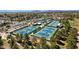 Aerial view of community tennis courts in a well-maintained and landscaped setting at 10013 N 106Th Pl, Scottsdale, AZ 85258