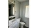 Bright bathroom featuring a decorative mirror, vanity and toilet at 11108 W Cameo Dr, Sun City, AZ 85351