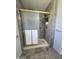 Updated bathroom featuring a walk-in shower with a gold frame and modern shower head at 11108 W Cameo Dr, Sun City, AZ 85351