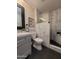 Modern bathroom featuring a stand-up shower with glass doors and a gray vanity at 11108 W Cameo Dr, Sun City, AZ 85351