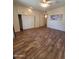 Spacious bedroom with built-in storage and closets, featuring wood-look flooring at 11108 W Cameo Dr, Sun City, AZ 85351