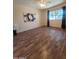 This bedroom features hardwood-look flooring, natural light, and wall art at 11108 W Cameo Dr, Sun City, AZ 85351