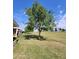 A view of the grassy golf course and blue sky provides a tranquil backdrop to this home's backyard at 11108 W Cameo Dr, Sun City, AZ 85351