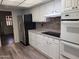 Well-equipped kitchen with stainless steel refrigerator and white appliances at 11108 W Cameo Dr, Sun City, AZ 85351