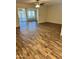 Spacious living room featuring hardwood floors and a view to adjacent rooms at 11108 W Cameo Dr, Sun City, AZ 85351