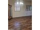 Cozy room showcasing wood-look flooring and a charming, decorative curio cabinet at 11108 W Cameo Dr, Sun City, AZ 85351