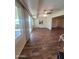 Bright living room featuring large windows, a ceiling fan, and wood-look floors at 11108 W Cameo Dr, Sun City, AZ 85351