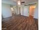 Open bedroom with modern flooring, ceiling fan, and lots of closet space at 11108 W Cameo Dr, Sun City, AZ 85351