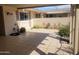 Enclosed patio with tiled floors, desert landscaping, and a privacy wall at 11108 W Cameo Dr, Sun City, AZ 85351