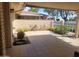 Covered tiled patio with privacy wall, desert landscaping and access to outdoor space at 11108 W Cameo Dr, Sun City, AZ 85351
