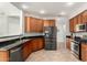 Kitchen featuring stainless steel appliances, black granite countertops and wood cabinets offer modern functionality at 12055 W Nadine Way, Peoria, AZ 85383