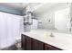 Well-lit bathroom with a vanity, modern fixtures, industrial pipe shelving and mirror with decor at 12622 W Catalina Dr, Avondale, AZ 85392