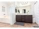 Bathroom featuring double sinks, a large mirror, and a separate soaking tub at 12622 W Catalina Dr, Avondale, AZ 85392