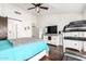 Cozy bedroom with dark wood flooring, ceiling fan, and workout equipment at 12622 W Catalina Dr, Avondale, AZ 85392