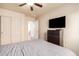 Bedroom with TV, closet, ceiling fan, and neutral color scheme, offering a relaxing space at 12622 W Catalina Dr, Avondale, AZ 85392