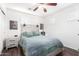 Bright and modern bedroom with light wood floors, headboard, and wall decor at 12622 W Catalina Dr, Avondale, AZ 85392