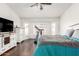 Inviting bedroom with plantation shutters, wood floors, entertainment center and a treadmill at 12622 W Catalina Dr, Avondale, AZ 85392