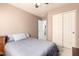 Comfortable bedroom showcasing soft carpet, a ceiling fan, and an adjoining entrance to another room at 12622 W Catalina Dr, Avondale, AZ 85392