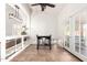 Bright dining area with modern light fixture, backyard access, and built-in shelving at 12622 W Catalina Dr, Avondale, AZ 85392