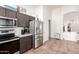 Spacious kitchen featuring stainless steel refrigerator and access to pantry and hallway at 12622 W Catalina Dr, Avondale, AZ 85392