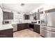 Updated kitchen with stainless steel appliances, tile flooring and bright countertops at 12622 W Catalina Dr, Avondale, AZ 85392