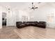Spacious living room featuring high ceilings, ceiling fan, and neutral-toned flooring at 12622 W Catalina Dr, Avondale, AZ 85392