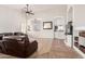 Spacious living room featuring high ceilings, ceiling fan, and an archway to the kitchen at 12622 W Catalina Dr, Avondale, AZ 85392