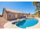 Private backyard with a refreshing pool, complemented by a covered patio and comfortable outdoor seating area at 12622 W Catalina Dr, Avondale, AZ 85392