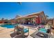Inviting backyard pool featuring a spacious patio and an outdoor kitchen, perfect for entertaining and relaxation at 12622 W Catalina Dr, Avondale, AZ 85392
