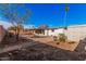A spacious backyard features desert landscaping, a covered patio, and a storage shed at 13008 N 28Th Pl, Phoenix, AZ 85032