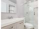 Bathroom featuring a sleek vanity, contemporary fixtures, and a glass-enclosed shower at 13008 N 28Th Pl, Phoenix, AZ 85032