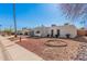 Exterior view of a home with a unique arched entrance and desert landscaping at 13008 N 28Th Pl, Phoenix, AZ 85032