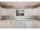 White kitchen cabinets and updated countertops enhance this kitchen, offering a clean and modern feel at 13008 N 28Th Pl, Phoenix, AZ 85032
