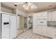 Bright kitchen featuring white cabinets, appliances, and tile flooring at 13008 N 28Th Pl, Phoenix, AZ 85032