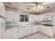 Well-lit kitchen featuring white cabinets, a window, and modern appliances at 13008 N 28Th Pl, Phoenix, AZ 85032