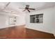 Bright living room with hardwood floors, a ceiling fan, and large windows for natural light at 13008 N 28Th Pl, Phoenix, AZ 85032