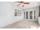 This enclosed patio includes a ceiling fan, tile floors, white walls, and access to the outdoors at 13008 N 28Th Pl, Phoenix, AZ 85032