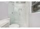Modern shower featuring white marble-like tiles, glass door, and contemporary fixtures at 13008 N 28Th Pl, Phoenix, AZ 85032