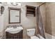 Cozy bathroom featuring a wooden vanity, open shelving, and shower with tan tile at 13013 N Panorama Dr # 120, Fountain Hills, AZ 85268