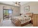 This carpeted bedroom features a ceiling fan and access to a covered patio at 13013 N Panorama Dr # 120, Fountain Hills, AZ 85268