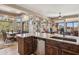 This open-concept kitchen boasts a sink, granite counters, and wooden cabinetry at 13013 N Panorama Dr # 120, Fountain Hills, AZ 85268