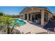 Lush backyard with sparkling pool, covered patio, desert landscaping, and ample space for outdoor entertaining and recreation at 13455 N 142Nd Ave, Surprise, AZ 85379