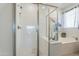 Modern bathroom features a glass enclosed shower and a soaking tub at 13455 N 142Nd Ave, Surprise, AZ 85379