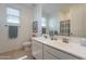 Bright bathroom featuring a double sink vanity, toilet, and large mirror at 13455 N 142Nd Ave, Surprise, AZ 85379
