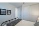 Bright bedroom features a bed, closet, and framed picture over a luggage rack at 13455 N 142Nd Ave, Surprise, AZ 85379