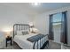 Clean bedroom with modern decor, featuring a black metal bed frame and neutral colors at 13455 N 142Nd Ave, Surprise, AZ 85379
