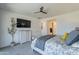 Spacious bedroom with ceiling fan, dresser, mounted TV, and ensuite bathroom at 13455 N 142Nd Ave, Surprise, AZ 85379