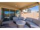 Comfortable seating on the covered patio offers a relaxing spot to unwind or entertain while enjoying backyard views at 13455 N 142Nd Ave, Surprise, AZ 85379