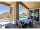 Well-appointed covered patio with comfortable outdoor dining and seating with a view of the backyard pool at 13455 N 142Nd Ave, Surprise, AZ 85379